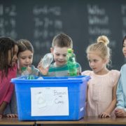 School Children Learning To Recycle Plastic Bottles