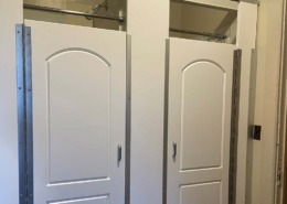 Row of Hiny Hider shower doors that are closed